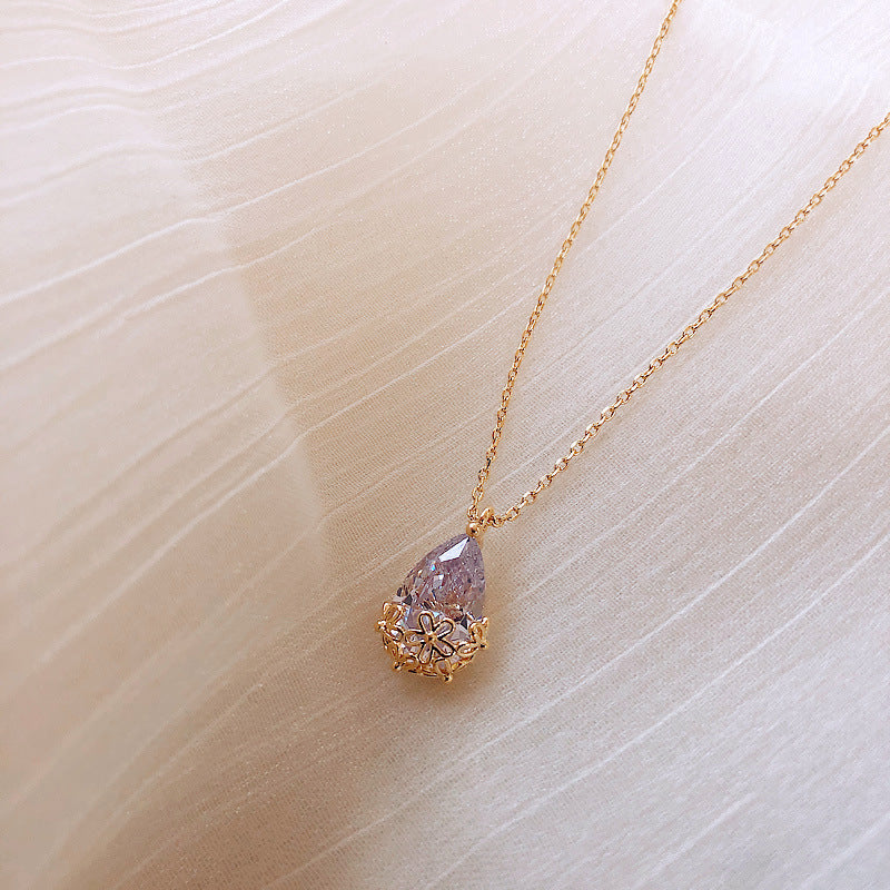 Add a touch of sophistication to any outfit with our crystal water drop pendant necklace. This elegant jewelry piece is perfect for any occasion, from weddings to formal events. Shop now and let your inner sparkle shine!
