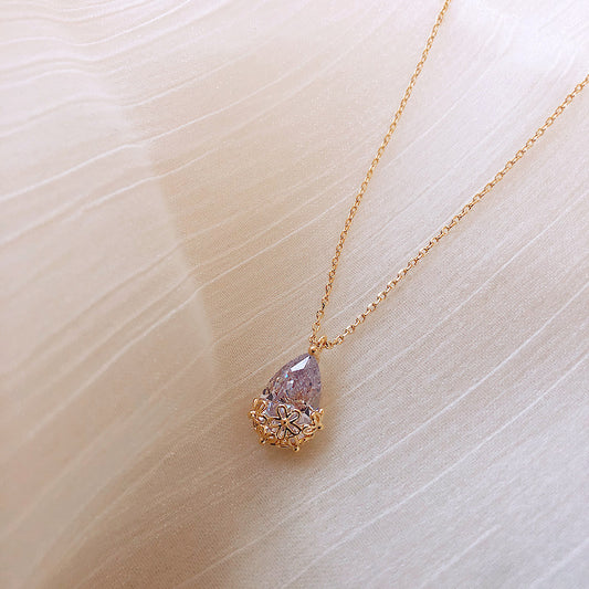 Add a touch of sophistication to any outfit with our crystal water drop pendant necklace. This elegant jewelry piece is perfect for any occasion, from weddings to formal events. Shop now and let your inner sparkle shine!